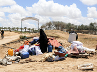 Displaced Palestinians are unloading their belongings to set up shelter in Khan Yunis, in the southern Gaza Strip, on May 6, 2024, after lea...