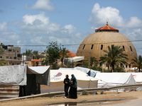 Displaced Palestinians are setting up shelter in Khan Yunis after leaving Rafah in the southern Gaza Strip with their belongings following a...