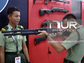 Visitors are trying the demo rifle at the Defense Services Asia (DSA) Exhibition and the National Security International Exhibition (NATSEC)...