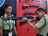 Visitors are trying the demo rifle at the Defense Services Asia (DSA) Exhibition and the National Security International Exhibition (NATSEC)...