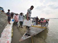 Polling officials in India are traveling by boat to reach their respective polling booths in Kamrup District, Assam, on May 6, 2024, a day b...