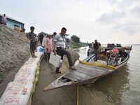 Polling officials in India are traveling by boat to reach their respective polling booths in Kamrup District, Assam, on May 6, 2024, a day b...