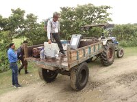 Election officials are carrying EVMs and other materials on a tractor to their respective polling booths on the eve of the third phase of vo...