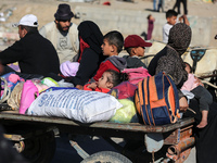 Displaced Palestinians are arriving in Khan Yunis with their belongings after leaving Rafah in the southern Gaza Strip due to an evacuation...