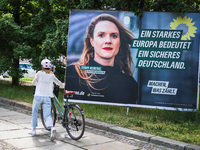 A person is passing by an election campaign poster of the German Green Party candidate Terry Reintke, which reads: ''A strong Europe means a...