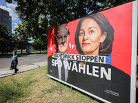 A person is walking past an election campaign poster of the Social Democratic Party of Germany (SPD) featuring Federal Chancellor Olaf Schol...