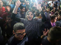 Displaced Palestinians in Deir Al-Balah, Gaza Strip, celebrate following Hamas' unilateral acceptance of Egyptian truce proposals, pending c...