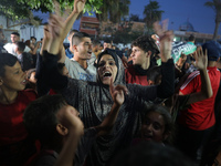 Displaced Palestinians in Deir Al-Balah, Gaza Strip, celebrate following Hamas' unilateral acceptance of Egyptian truce proposals, pending c...