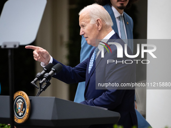 President Joe Biden points at a guest after welcoming guests to a Cinco de Mayo reception in the White House Rose Garden, Washington, DC, Ma...