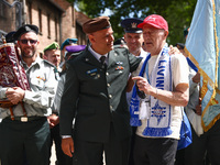 Gen. Ofir Levius talks to Holocaust survivor while attending the 36th anniversary of 'International March of the Living' at the former Nazi-...