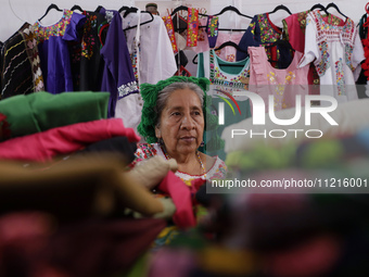 A woman is selling fabrics at the Feria del Apapacho in Mexico City, at the National Museum of Popular Cultures, on the eve of Mother's Day....