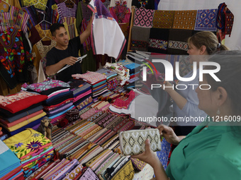 People are selling fabrics at the Apapacho Fair in Mexico City, at the National Museum of Popular Cultures, on the eve of Mother's Day. Prod...