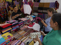 People are selling fabrics at the Apapacho Fair in Mexico City, at the National Museum of Popular Cultures, on the eve of Mother's Day. Prod...