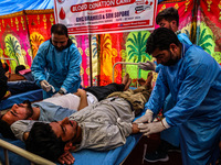 Health care workers are collecting blood from volunteers participating in a blood donation camp organized by the NGO ''Sopore Blood Donors''...