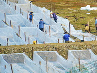Farmers are installing net cages for aquaculture at a leech breeding base in Anqing, Anhui Province, China, on May 7, 2024. (