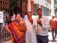 Voters are showing marks of indelible ink after casting their votes at a polling booth during the 3rd Phase of the India General Elections-2...