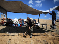 Displaced Palestinians are setting up tents on a beach near Deir el-Balah in the central Gaza Strip on May 7, 2024, amid the ongoing conflic...