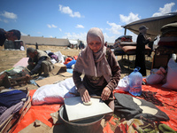 Displaced Palestinians are preparing a meal on a beach near Deir el-Balah, in the central Gaza Strip, on May 7, 2024, amid the ongoing confl...