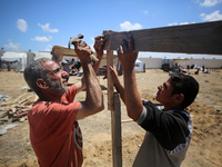 Displaced Palestinians are setting up tents on a beach near Deir el-Balah in the central Gaza Strip on May 7, 2024, amid the ongoing conflic...