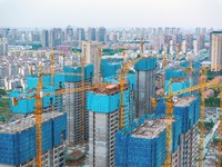Workers are working at the real estate construction site of a resettlement housing project along the Beijing-Hangzhou Grand Canal in Huai'an...
