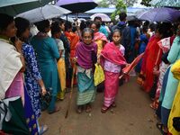 An elderly voter is leaving after casting her ballot at a polling station during the third phase of voting in India's general elections in G...