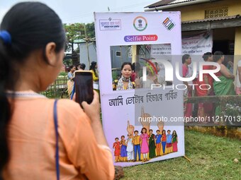 Voters are posing for a picture with their inked fingers after casting their ballots at a polling station during the third phase of voting o...