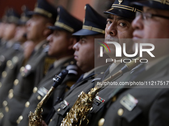 The musical orchestra of the Ministry of National Defence is performing at the National Palace in Mexico City. (