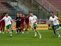 Floriana soccer players Mattias Veselji (L), Carlo Zammit Lonardelli (C), Dunstan Vella (2nd R, partially hidden), and Kemar Reid (R) are ce...
