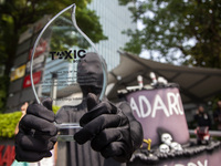 Environmental activists from Enter Nusantara, Market Force, and Greenpeace Indonesia, who are part of the Civil Society Coalition, are perfo...