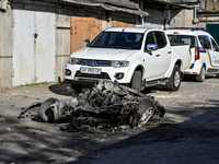A fragment of a destroyed car is lying on the premises of a garage cooperative following a massive Russian missile and drone attack overnigh...