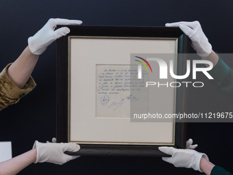 LONDON, UNITED KINGDOM - MAY 08, 2024: Staff members hold a famous napkin on which the commitment of a contract was written by Carles Rexach...