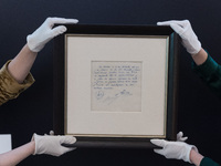 LONDON, UNITED KINGDOM - MAY 08, 2024: Staff members hold a famous napkin on which the commitment of a contract was written by Carles Rexach...