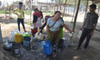 Indian women’s collect drinking water from a supply line on the World Water Day in Dimapur...