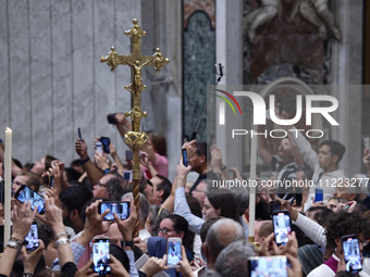 Pilgrims are taking photos during the Vespers prayer service on the day of the Ascension of Jesus Christ at St. Peter's Basilica in the Vati...
