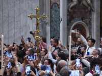 Pilgrims are taking photos during the Vespers prayer service on the day of the Ascension of Jesus Christ at St. Peter's Basilica in the Vati...
