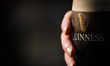 DALKEY, IRELAND - MAY 11: A person holds a pint of Guinness outside a local pub, on May 1...