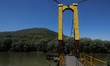 People are walking on a pedestrian Metallic Bridge on a hot summer day in Baramulla, Jammu...