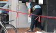A police officer is collecting evidence at the crime scene. A 31-year-old male is in criti...