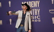 Parker McCollum is posing with his prize in the press room during the 59th Academy of Coun...