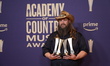 Chris Stapleton is posing with his prizes in the press room during the 59th Academy of Cou...