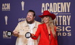 Jelly Roll and Lainey Wilson are posing with their prizes in the press room during the 59t...