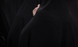 A veiled Iranian woman is participating in a mourning ceremony for the late Iranian Presid...