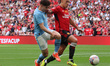 Manchester City's Julian Alvarez is tussling with Manchester United's Lisandro Martinez du...