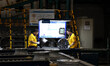 Workers are producing wheels at a workshop of an automobile wheel manufacturer in Binzhou,...