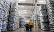 A worker is producing a wheel hub at a workshop of an automobile wheel manufacturer in Bin...