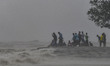 Local people are observing the sea waves during the landfall of Cyclone Remal at a beach i...