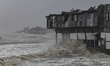 Shops are being damaged by the sea waves and heavy wind during the landfall of Cyclone Rem...