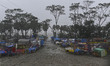 Shops are being damaged by heavy wind during the landfall of Cyclone Remal, at a beach in...