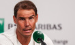 Rafael Nadal is gesturing during a press conference after losing his match against Alexand...
