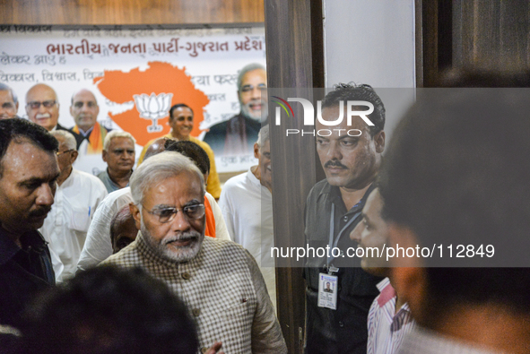 Narendra Modi flashed a triumphant V as he reached his party's office in Gandhinagar